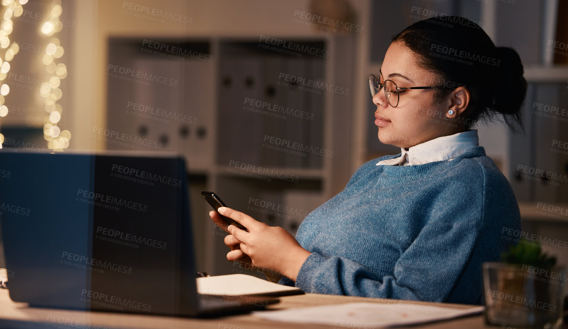 Buy stock photo Business woman, phone and typing in office at night, texting or social media in workplace. Bokeh, overtime technology and female employee with mobile smartphone for web scrolling or internet browsing