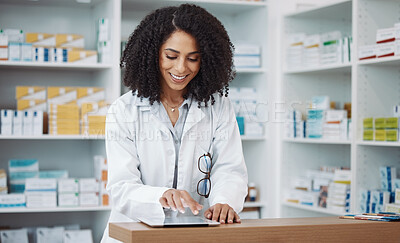 Buy stock photo Pharmacy, medical and pharmacist typing on a tablet searching medicine online, internet and web in a dispensary. Black woman, drugs and healthcare professional in a drugstore for health products 