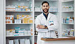 Pharmacist, man and arms crossed with medicine, portrait and confident with trust, healthcare and happiness. Face, Latino male and employee with smile, pharmacy and wellness in store and happy expert