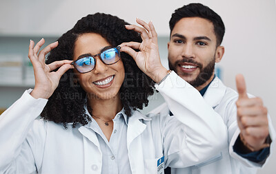 Buy stock photo Vision portrait, doctor thumbs up and smile of a female healthcare worker in a hospital. Agreement, glasses choice and happy woman looking at lens and frames options in a optometrist clinic 