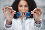 Optometry, vision and optometrist with glasses in a clinic to test and choose a prescription lens. Healthcare, eye care and pov of a female optician with spectacles or eyewear in a optical store.