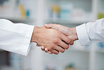 Doctor, handshake and partnership in support at pharmacy for healthcare success, promotion or deal at clinic. Medical expert shaking hands in teamwork for life insurance, b2b or pharmaceutical needs