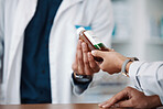 Hands, bottle or medicine with a pharmacist and customer in a drugstore for prescription treatment. Healthcare, medical or pharmacy with a consultant and patient in a dispensary for insurance
