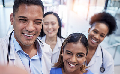 Buy stock photo Wink, portrait and group selfie of doctors in hospital with pride, smile and clinic teamwork. Happy medical employees, diversity and funny profile picture to update about us on website, face or trust