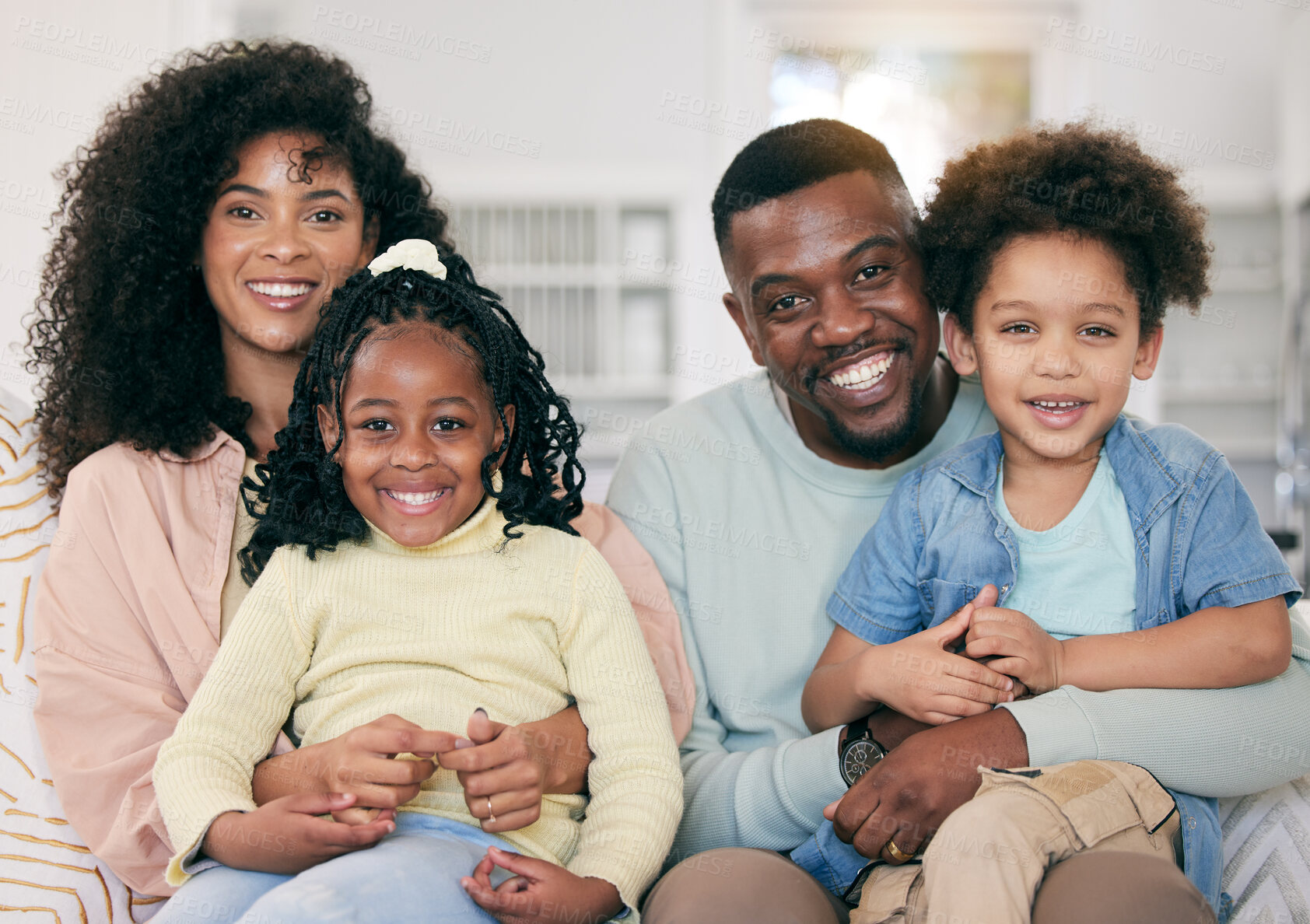 Buy stock photo Happy, love and portrait of a black family in the living room sitting, relaxing and bonding together. Happiness, smile and young African man and woman resting with their children on a sofa at home.