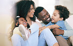 Happy family, laugh and relax on a sofa, bonding and playing in their home together. Laughter, smile and children with parents on a couch, cheerful and enjoy game, moment and weekend in a living room