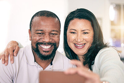 Buy stock photo Selfie, interracial and couple with a hug for bonding, memory together or quality time. Smile, embrace and mature man and woman smiling for a picture for social media, love or happiness at home