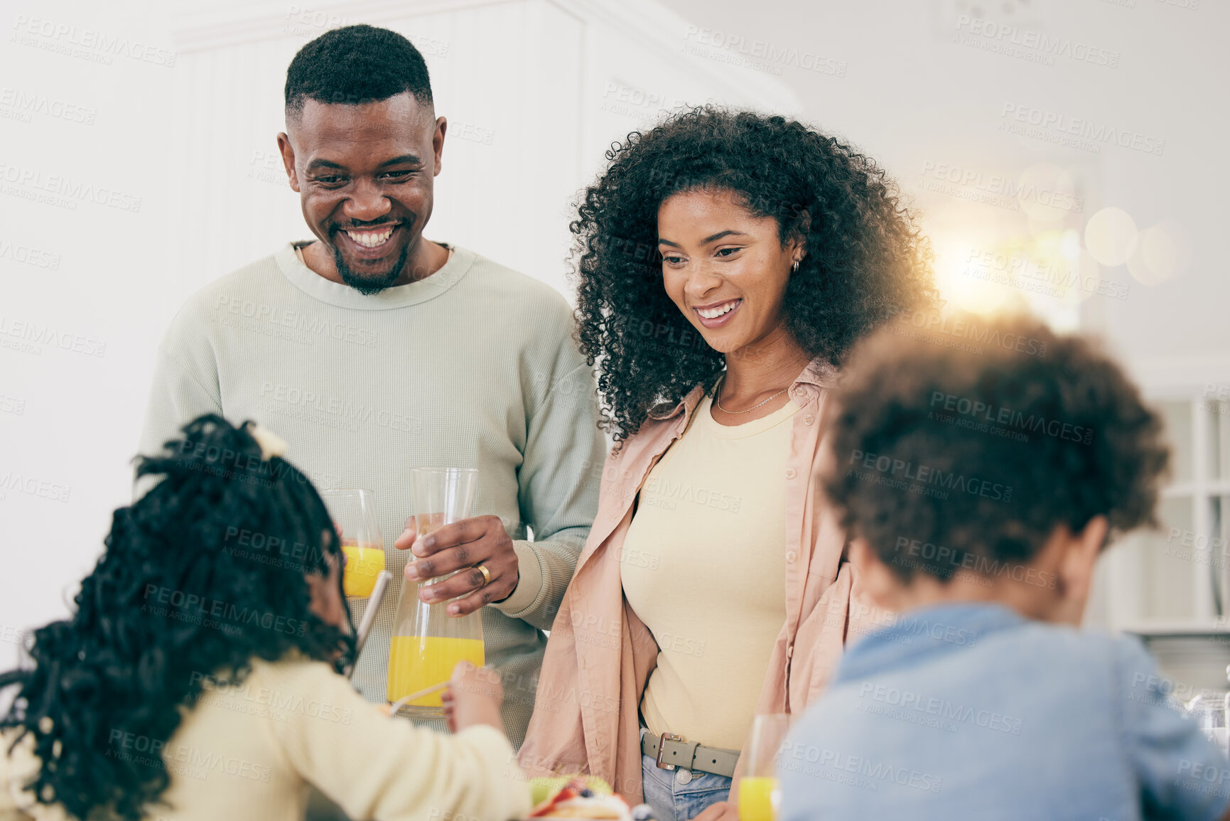 Buy stock photo Family, happiness and have breakfast together in home, mother and father with children, smile with juice and nutrition. Black people, joy and unity, bonding over meal, love and care in relationship