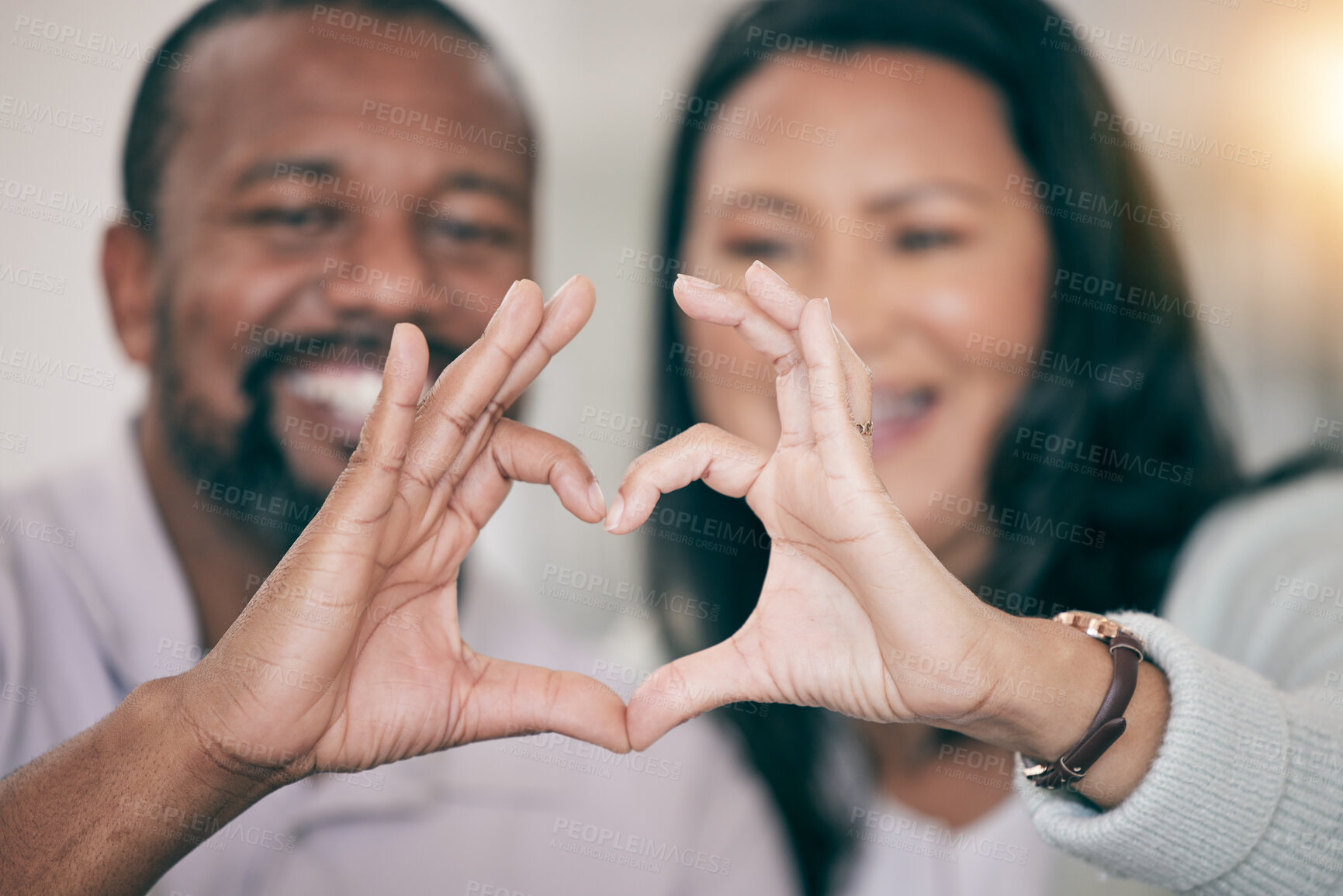 Buy stock photo Hands, love and heart with a couple in their home to relax together in the living room closeup. Hand gesture, emoji or romance with a senior man and woman bonding while sitting in their house