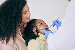 Children, black family and a girl at the dentist for oral hygiene or a checkup to search for a cavity or gum disease. Kids, dental or healthcare with a female child and mother at the orthodontist