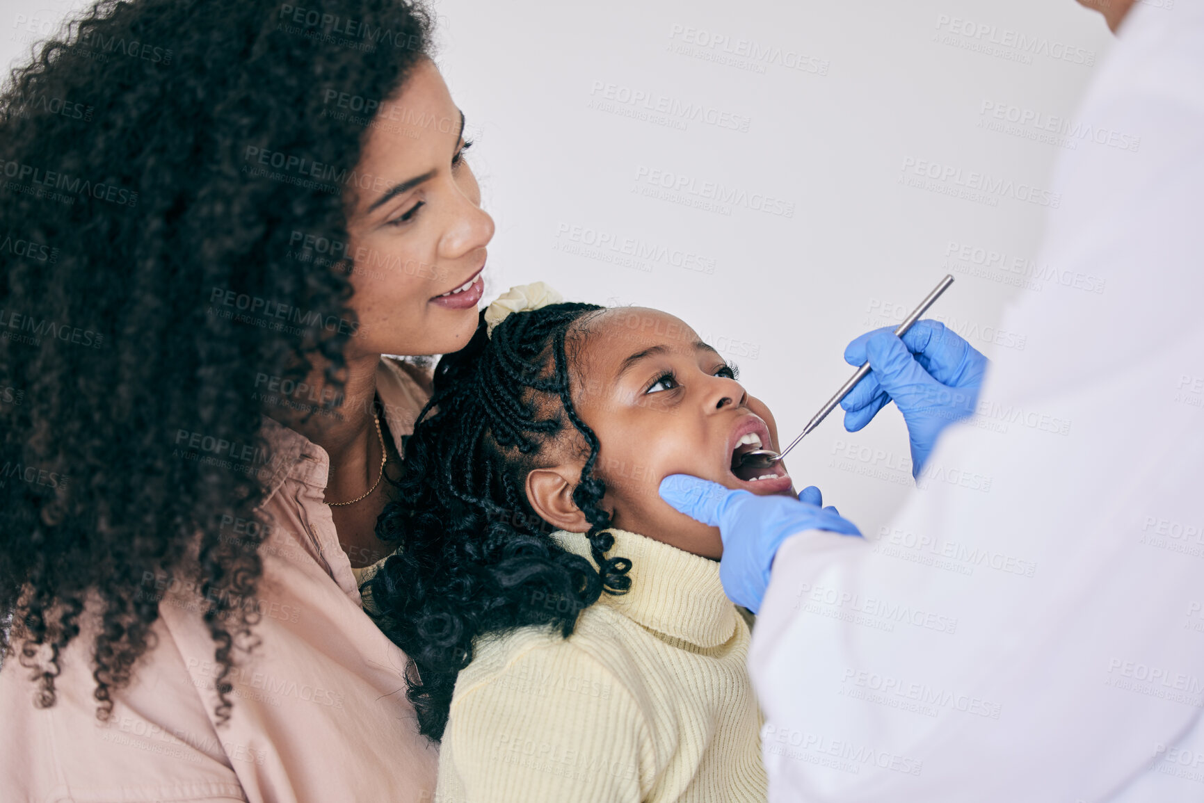 Buy stock photo Children, mother and a girl at the dentist for oral hygiene or a checkup to search for a cavity or gum disease. Kids, dental or healthcare with a female child and mother at the orthodontist