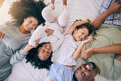 Buy stock photo Happy, relax and morning with black family in bedroom from top view for wake up, bonding and affectionate. Weekend, smile and care with parents and children at home for playful, funny and free time