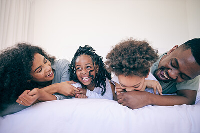 Buy stock photo Laugh, relax and morning with black family in bedroom for wake up, bonding and affectionate. Weekend, smile and care with parents and children at home for playful, funny and free time together