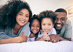 Black family smile, happiness and portrait of a mother, father and girl children on a house bed. Bedroom, home and happy kids with parent love and support from mama and dad together in the morning