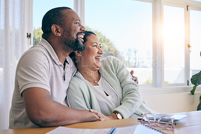 Buy stock photo Love, laughing and hugging with a senior couple in their home, sitting by a table while thinking of a future retirement. Comic, funny or humor with a mature man and woman bonding together in a house