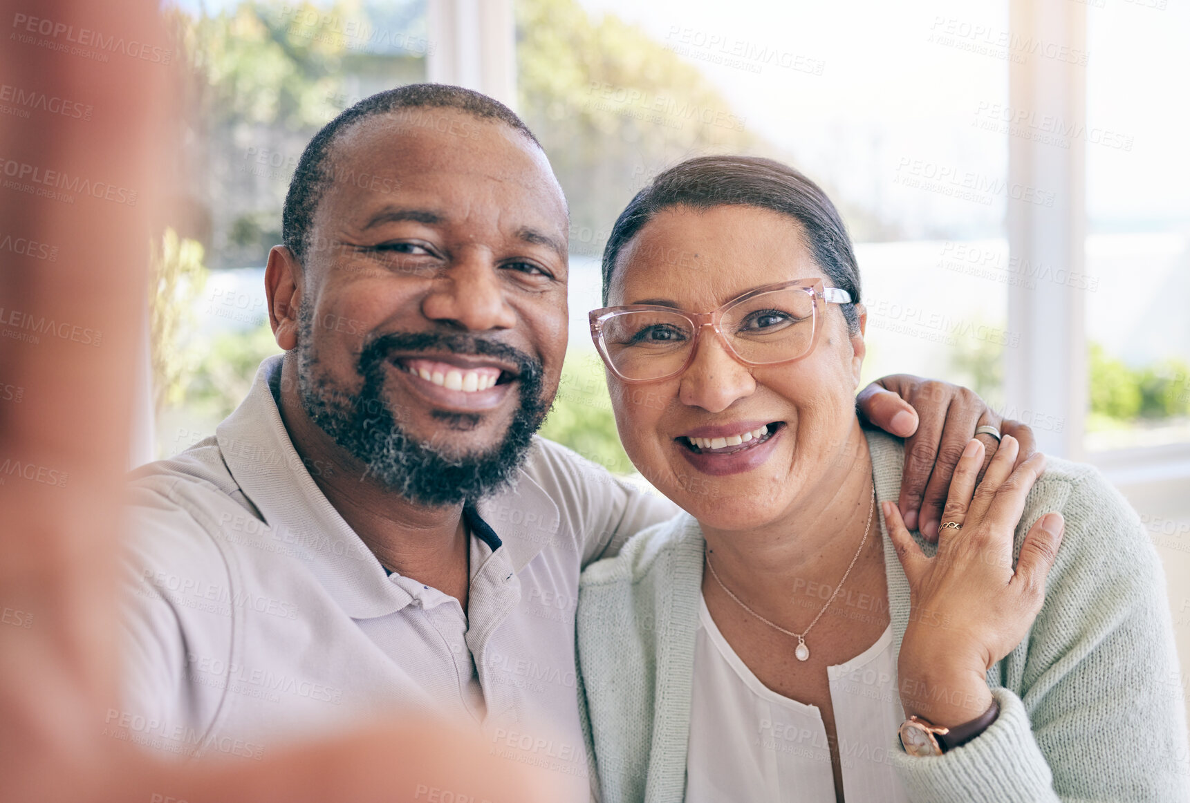 Buy stock photo Happy, mature and portrait of an interracial couple with a selfie for a memory, together and relationship. Smile, love and a black man with a woman taking a photo, looking and joyful at home