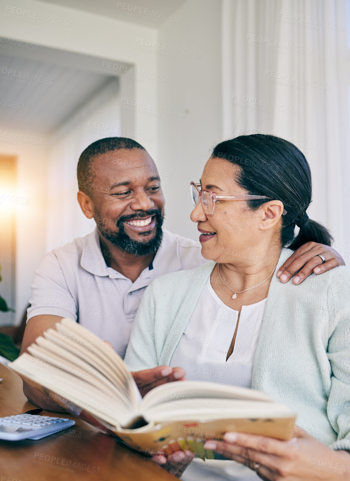 Buy stock photo Home reading, black couple and marriage with love, support and care in a house. Book, smile and happiness of a older woman and man together feeling happy in early retirement in the morning with books