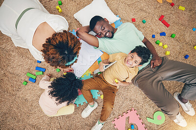 Buy stock photo Top view, family and parents with children on floor with toys, number puzzle and bonding at home. Happy, educational games and mom, dad and kids smile for fun activity, creative learning and relax 