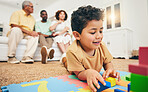 Family, happy and boy on floor with toys for playing, creative activity and having fun in living room. Education, child development and kid enjoy building blocks, games and relax with parents at home