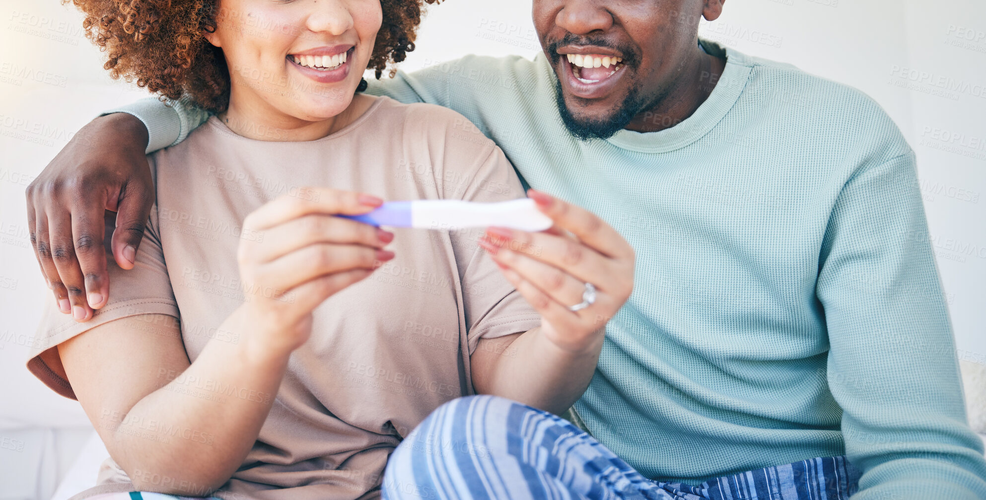 Buy stock photo Couple, happy and pregnancy test, smile and excited for good news, positive and results in their house. Hands, woman and man with home testing kit, pregnant and fertility or ivf success while hugging