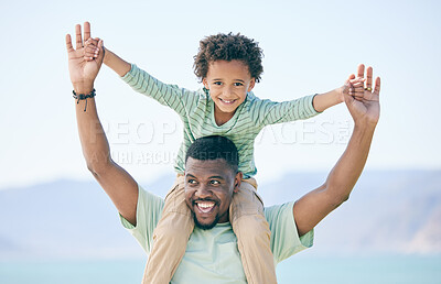 Buy stock photo Black family, father and a son sitting on shoulders while outdoor in nature together during a beach vacation. Love, sky or kids with a parent carrying his male child while walking on the coast
