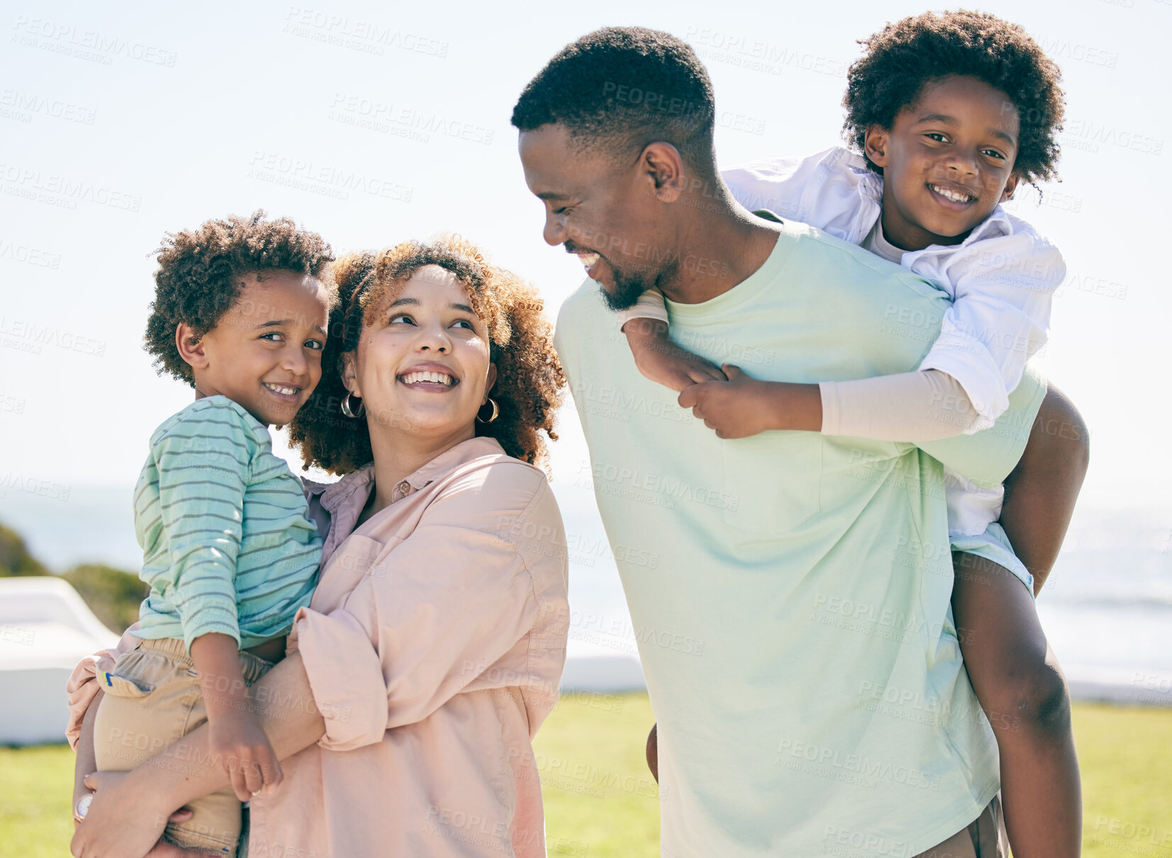 Buy stock photo Smile, love and happy black family at beach for summer travel, vacation and piggyback in a garden. Cheerful, relaxed and trip with children and parents embrace and bond while traveling in Mexico