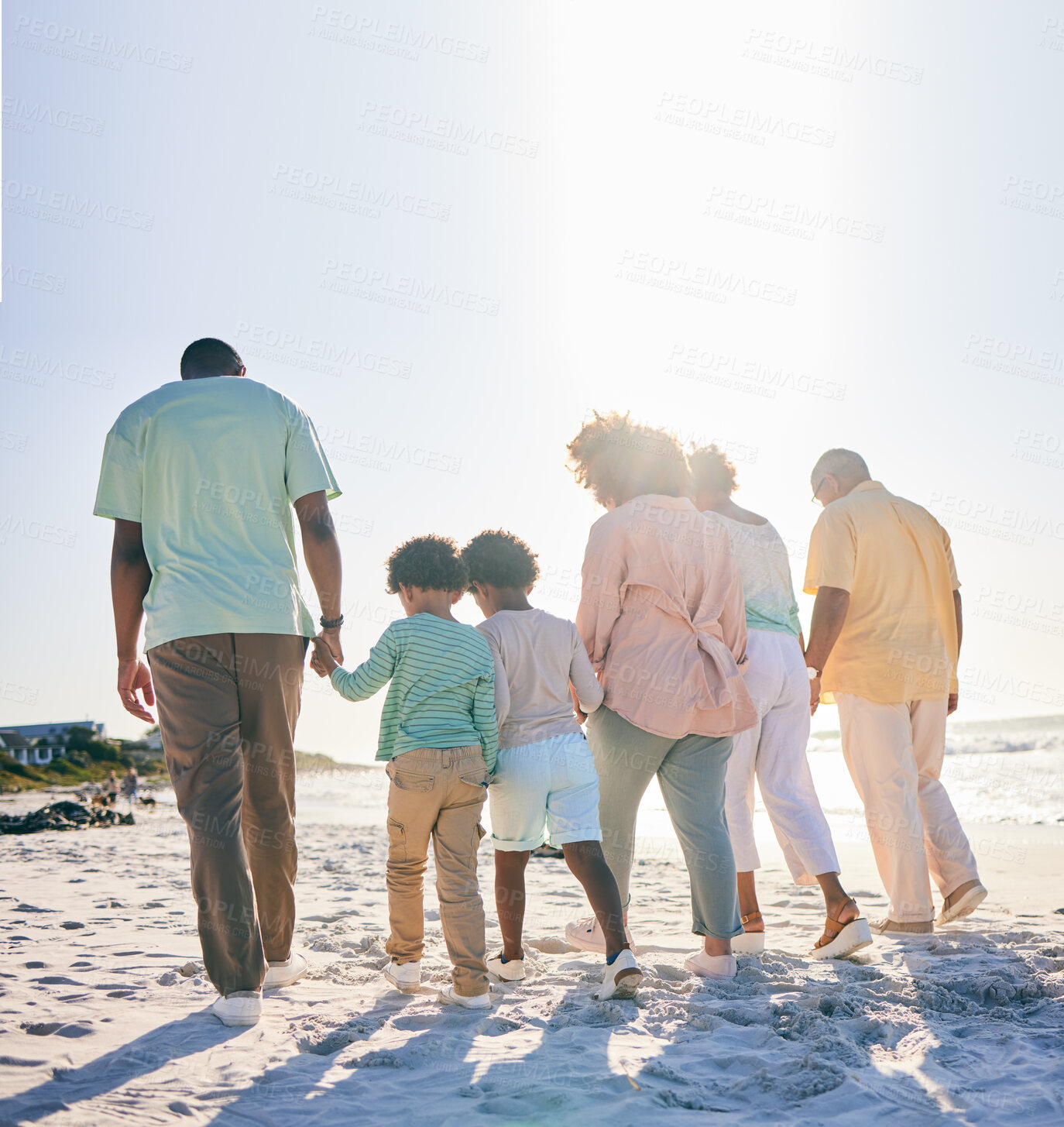 Buy stock photo Rear view, holding hands and family at a beach for travel, vacation and holiday on summer mockup. Behind, walking and trip with children, parents and grandparents bond while traveling in Miami