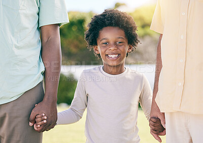 Buy stock photo Portrait of kid, smile and holding hands of parents, happy in backyard garden and support, trust and love in adoption diversity. Family, children and biracial couple with black child in park together