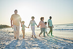 Family, grandparents and children at beach, holding hands and jump with swing, happiness or bonding on holiday. Parents, kids and senior people for love, vacation or summer sunshine in morning by sea