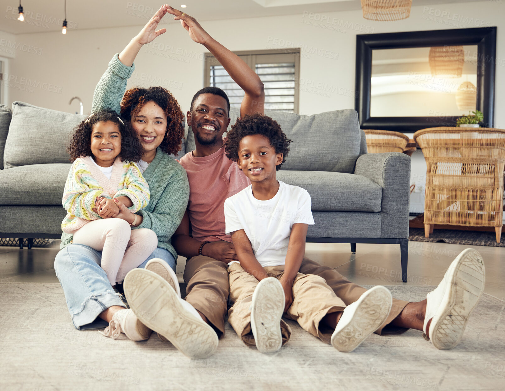 Buy stock photo Family, portrait and protection, love and insurance for security with parents and children. Hands together, roof and happy people in living room, unity and safety for life and home cover with smile