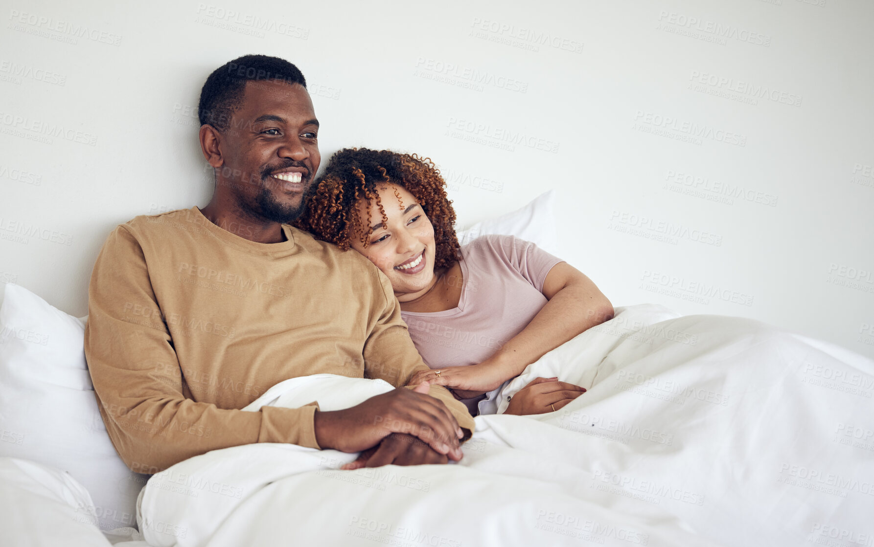 Buy stock photo Black couple, bedroom tv watching and bed rest in the morning together with love and care. Happiness, home and smile of a woman and man feeling happy about streaming a movie in a house with bonding