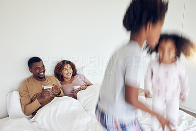 Buy stock photo Mother, father and children jump on bed in morning for playing together, fun and quality time at home. Love, black family and happy mom and dad with motion blur kids with energy, jumping and excited