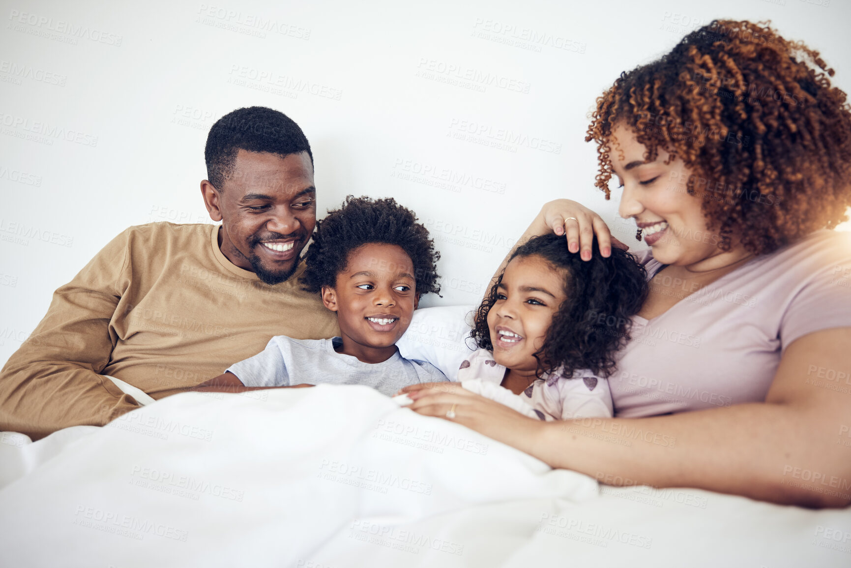 Buy stock photo Family, father and mother with children on bed relaxing together for fun morning or holiday break at home. Happy dad, mom and kids relax and lying in bedroom enjoying comfort and bonding time
