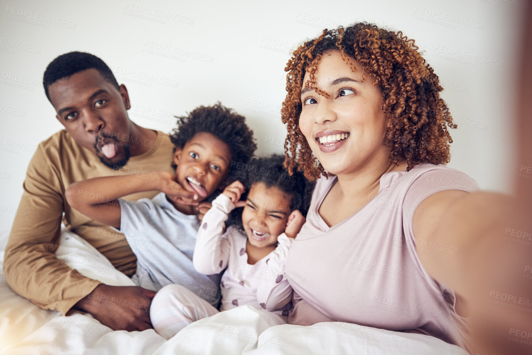 Buy stock photo Black family, selfie and funny face portrait in home bedroom, smile and having fun together. Interracial, comic and father, mother and children taking pictures for happy memory and social media.