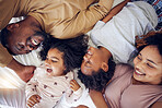 Happy, above and black family laughing in bed, smile and bonding while resting in their home. Top view, smile and children waking up with mother and father in a bedroom, playful and having fun 
