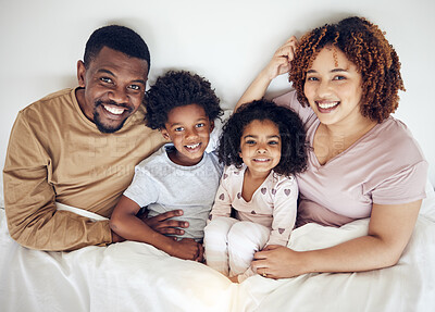 Buy stock photo Family, bed and happy portrait of a mother, father and children in a bedroom in the morning. Home, happiness and smile of a mom, kids and papa together with bonding, parent care and love in a house