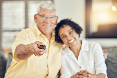 Buy stock photo Portrait of senior couple watching tv on sofa with comedy show, film or movies at home together with love and hug. Biracial people or woman with elderly partner watch television and relaxing on couch