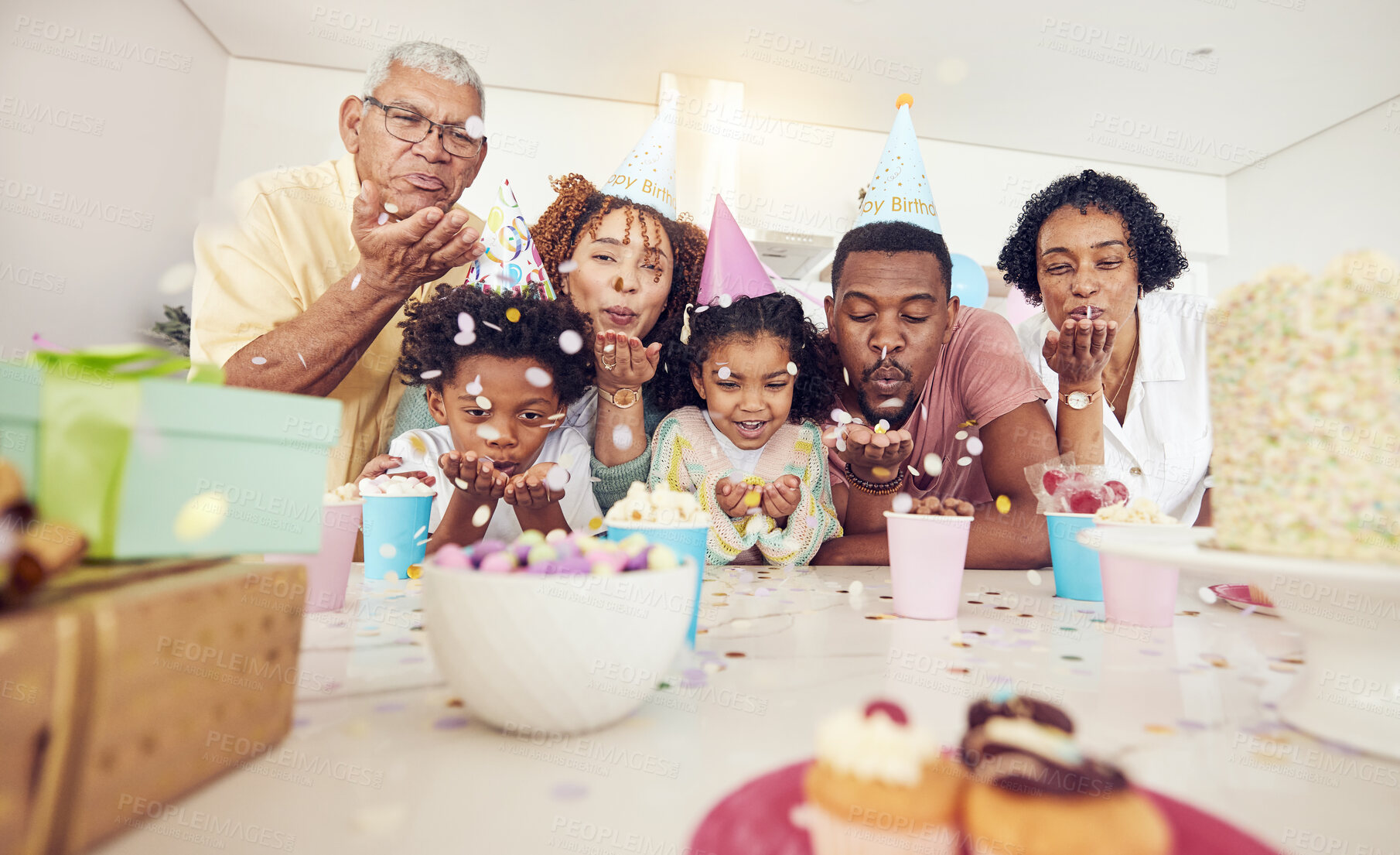 Buy stock photo Birthday, party and confetti with family in kitchen for celebration, bonding and affectionate. Happiness, excited and grandparents with parents and child at home for surprise, fun and event 