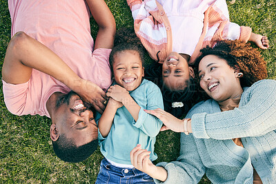 Buy stock photo Top view, happiness and black family on grass, quality time and carefree in park, break and smile. Mother, father and children in backyard, cheerful and playful together for bonding, loving and relax