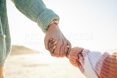 Buy stock photo Family, mother and kid holding hands at beach, travel and summer holiday with sunshine and together outdoor. Trust, support with woman and girl on vacation, love and care in nature with closeup