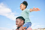 Child, black man and piggy back with blue sky on playful family holiday in Australia with freedom, beach and fun. Travel, smile and happy dad and girl playing, flying and bonding together on vacation