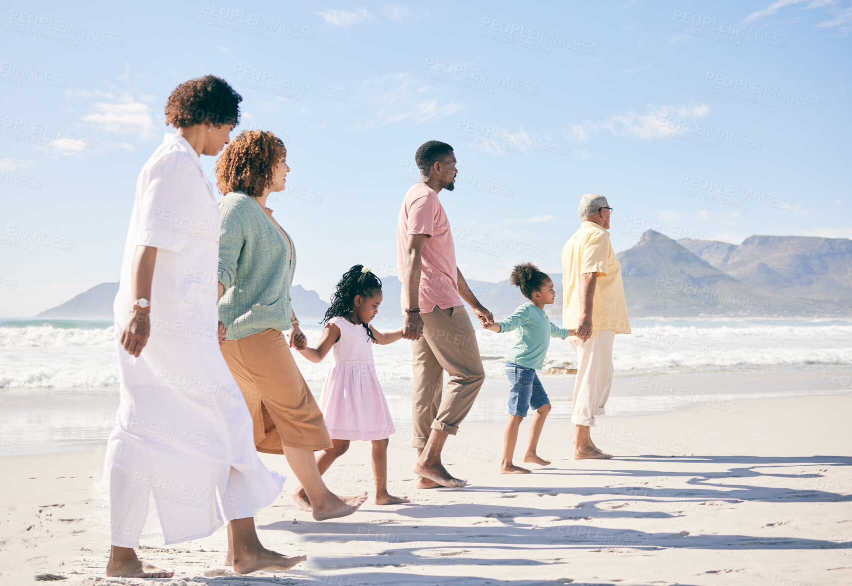 Buy stock photo Family is walking on beach, travel and holding hands with generations, unity and freedom with love, together outdoor. Grandparents, parents and children, people on holiday with tropical destination