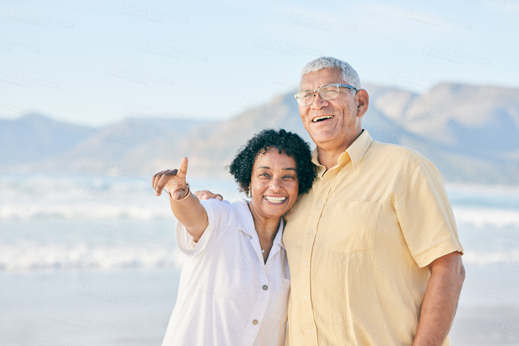 Buy stock photo Old couple at beach, hug and travel with smile, retirement and love outdoor, vacation with view and relax in nature. Peace, zen and man with woman pointing, happiness and wellness in Bali on holiday