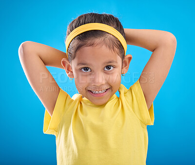 Buy stock photo Young girl, portrait and studio with a student feeling happy with a smile and blue background. Isolated, cute and adorable child face in a yellow outfit with happiness, joy and cheerful smiling