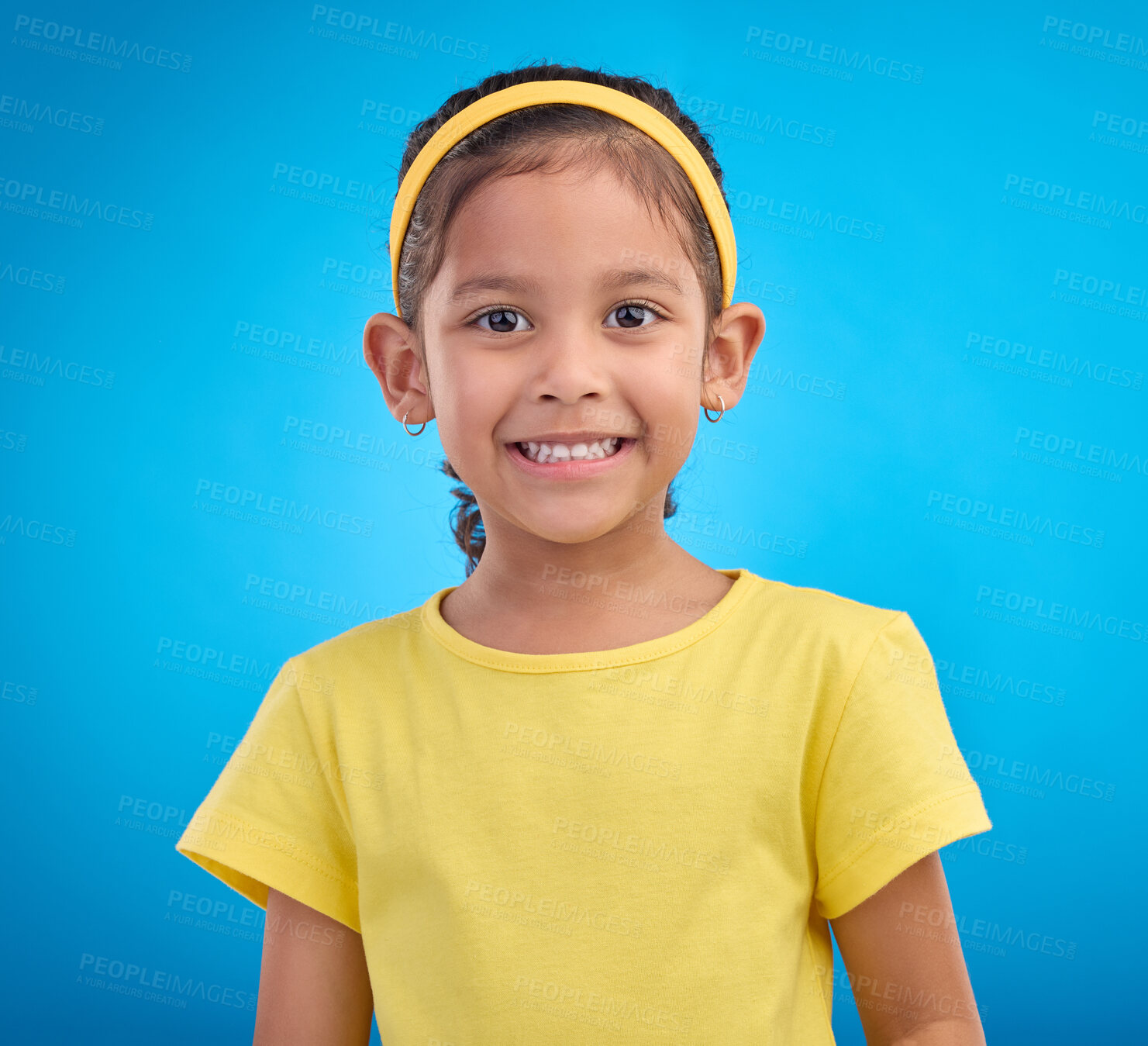 Buy stock photo Happy, smile and portrait of girl in studio for natural, youth and confident isolated on blue background. Happiness, break and positive with face of young child for cute, adorable and trendy style