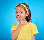 Thinking, idea and face of child in studio with contemplation, thoughtful and planning expression. Ideas mockup, innovation and young girl on blue background for brainstorming, question and curious