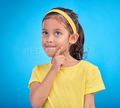 Buy stock photo Thinking, idea and face of child in studio with contemplation, thoughtful and planning expression. Ideas mockup, innovation and young girl on blue background for brainstorming, question and curious