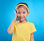 Phone call, smile and portrait of child on blue background for talking, speaking and chatting online. Technology, communication mockup and face of happy girl in conversation on smartphone in studio