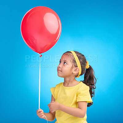 Buy stock photo Young girl, studio and red balloon of a an kid alone ready for a birthday party to celebrate. Celebration event and female child holding balloons in the air with isolated blue background  