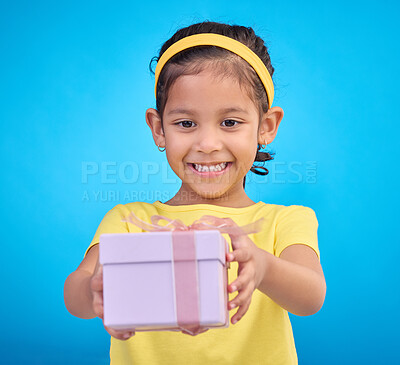 Buy stock photo Box, present and girl with smile, excited and cheerful against a blue studio background. Female child, kid and young person with gift, package and happiness with joy, excitement and product promotion